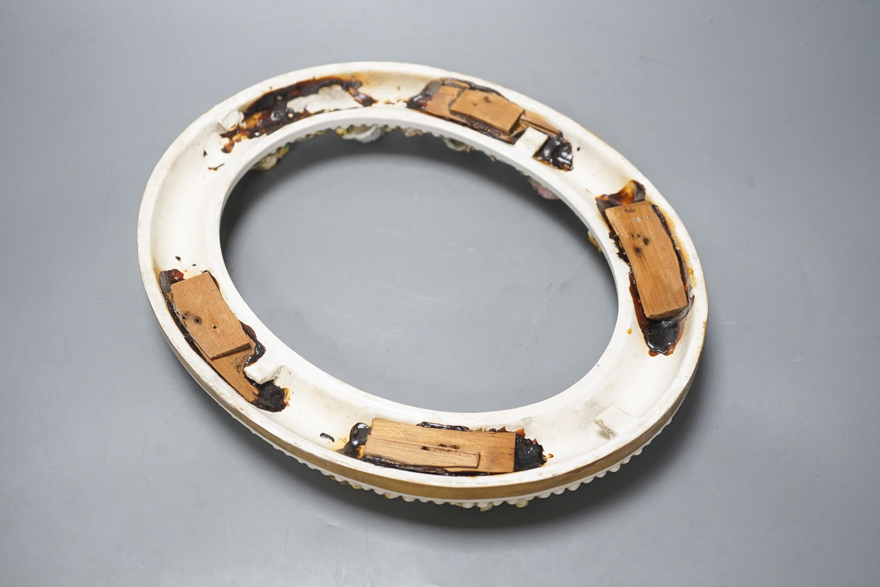 A 19th century English porcelain floral encrusted oval frame 32cm